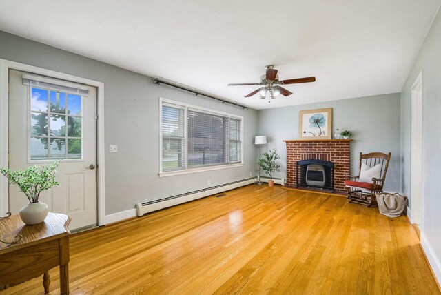 78 Stuart Ave, Stuarts Draft, VA 24477 - living area featuring a baseboard heating unit, light wood-style flooring, ceiling fan, and baseboards