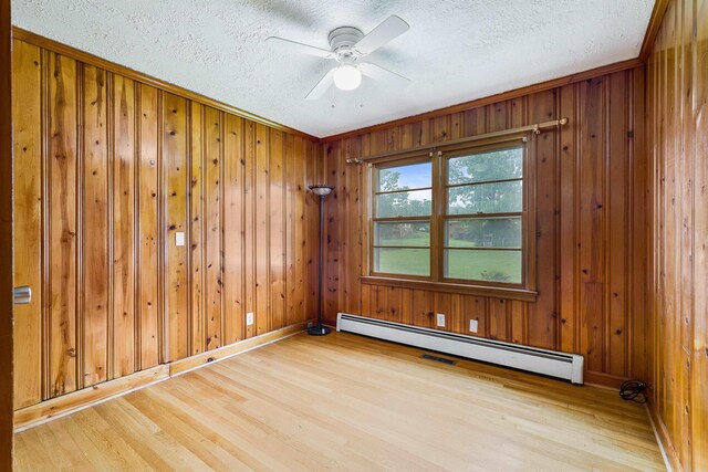 78 Stuart Ave, Stuarts Draft, VA 24477 - unfurnished room with light wood-type flooring, a baseboard heating unit, a textured ceiling, ceiling fan, and baseboards