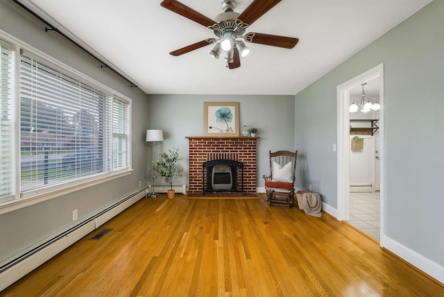 78 Stuart Ave, Stuarts Draft, VA 24477 - unfurnished living room with light wood-style flooring, a ceiling fan, a baseboard radiator, and baseboards