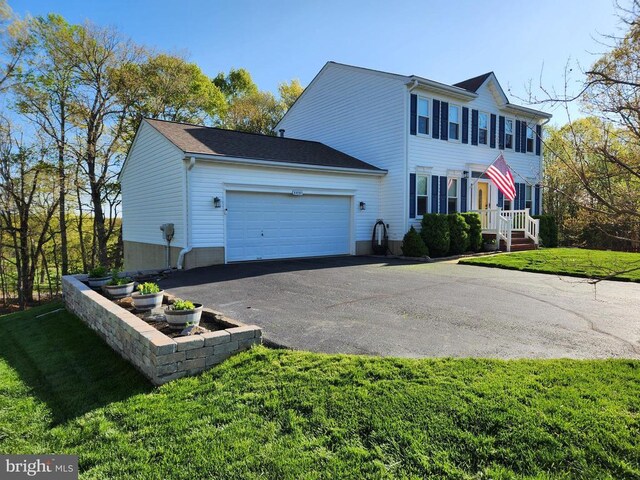 10010 Peppermill Ct, Fredericksburg, VA 22407 - view of front facade featuring asphalt driveway, an attached garage, and a front lawn