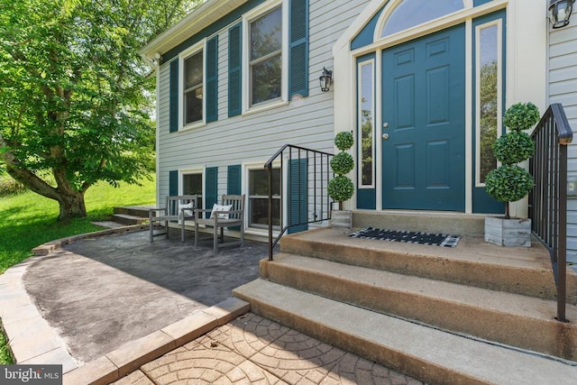 - view of exterior entry with a patio