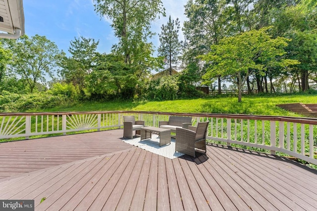  - deck featuring an outdoor living space and view of wooded area