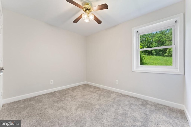  - carpeted spare room featuring baseboards and a ceiling fan