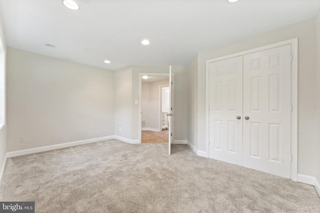  - unfurnished bedroom featuring carpet, a closet, and recessed lighting