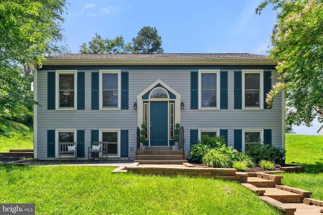 - raised ranch featuring entry steps and a front yard