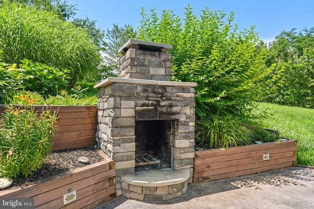  - view of patio with an outdoor stone fireplace