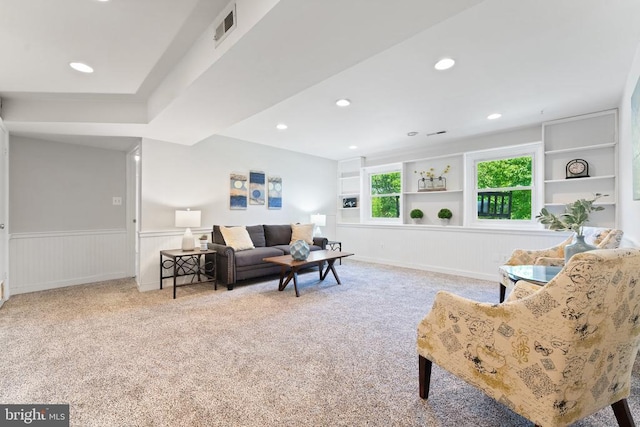  - carpeted living area with a wainscoted wall and recessed lighting