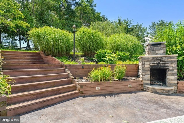  - view of patio / terrace with an outdoor stone fireplace