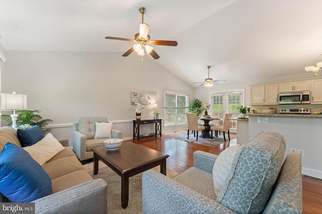  - living area featuring a ceiling fan, wood finished floors, high vaulted ceiling, and a chandelier