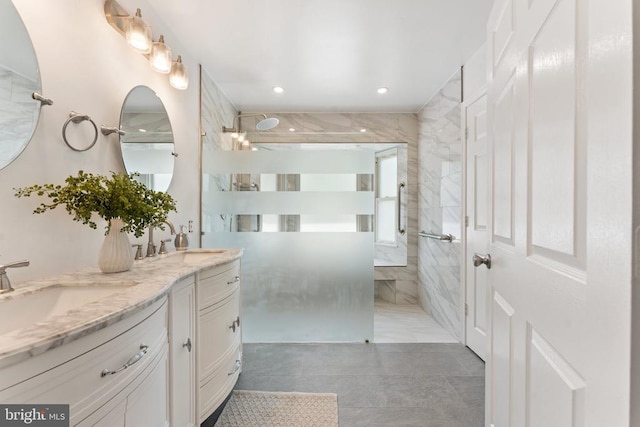  - bathroom featuring a marble finish shower, double vanity, and tile patterned floors