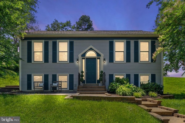  - bi-level home featuring entry steps and a front lawn