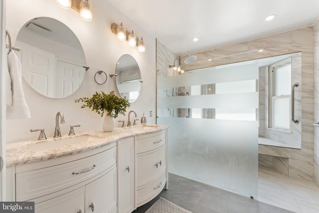  - bathroom with double vanity, a walk in shower, and recessed lighting