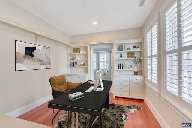 office with visible vents, light wood-style flooring, baseboards, and recessed lighting