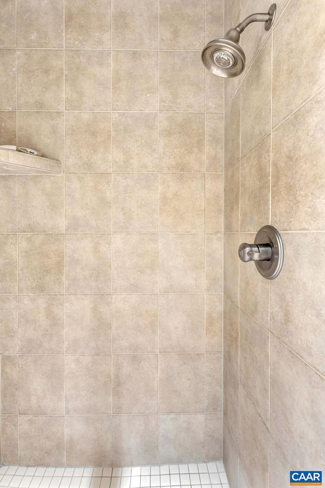 full bath with a tile shower