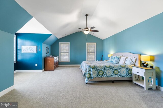 carpeted bedroom featuring baseboards, vaulted ceiling, and ceiling fan
