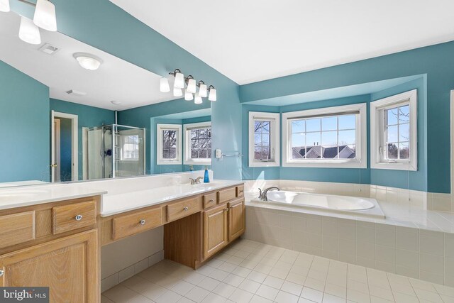 full bathroom featuring tile patterned floors, vanity, a stall shower, and a bath