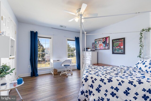 bedroom featuring wood finished floors, lofted ceiling, a ceiling fan, and baseboards