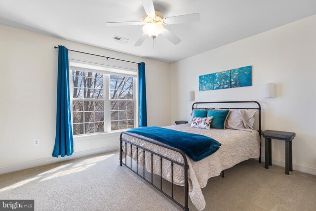 carpeted bedroom with baseboards and a ceiling fan