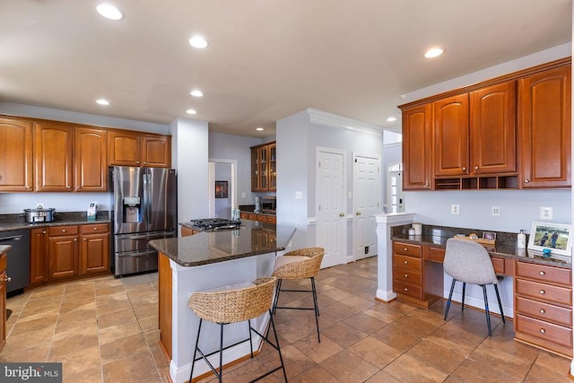 kitchen with appliances with stainless steel finishes, recessed lighting, a kitchen bar, glass insert cabinets, and a center island