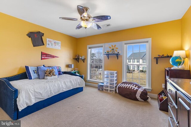 carpeted bedroom featuring baseboards and a ceiling fan