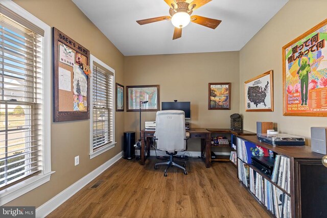 home office featuring wood finished floors, ceiling fan, and baseboards