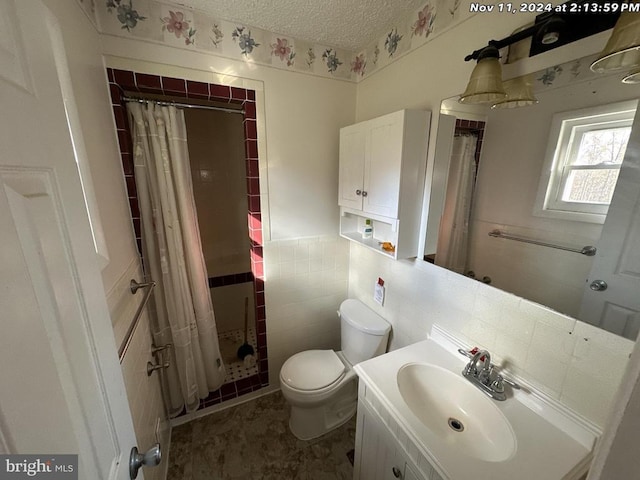 22064 Yellow Bottom Rd, Lignum, VA 22726 - full bathroom featuring tiled shower, a textured ceiling, toilet, vanity, and tile walls