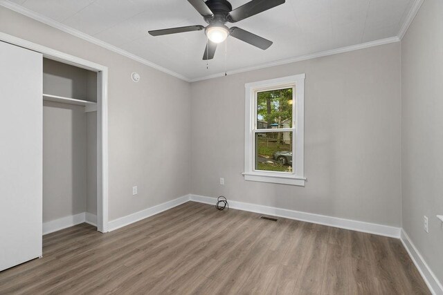 837 Faber Ave, Waynesboro, VA 22980 - unfurnished bedroom featuring wood finished floors, baseboards, crown molding, a ceiling fan, and a closet