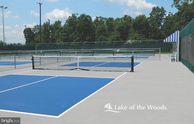 view of tennis court featuring fence