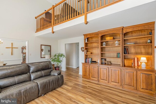 102 Spotswood Rd, Locust Grove, VA 22508 - living room with a towering ceiling, light wood-style flooring, baseboards, and a chandelier