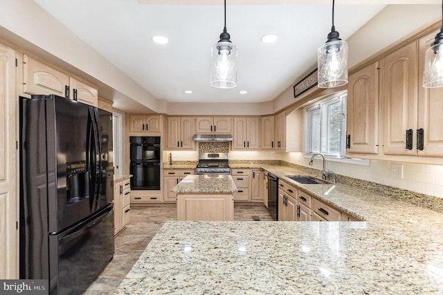 kitchen featuring black appliances, a sink, light brown cabinetry, under cabinet range hood, and light stone countertops