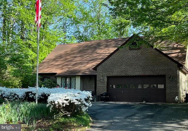 102 Spotswood Rd, Locust Grove, VA 22508 - view of front of home with an attached garage, brick siding, asphalt driveway, and a shingled roof