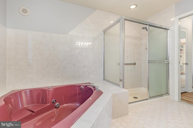 full bath with a stall shower, a tub with jets, recessed lighting, and tile patterned floors