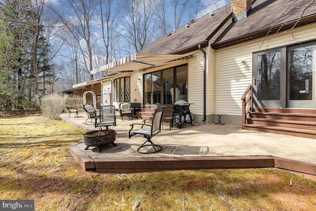 back of house featuring a fire pit, roof with shingles, a patio, a chimney, and entry steps