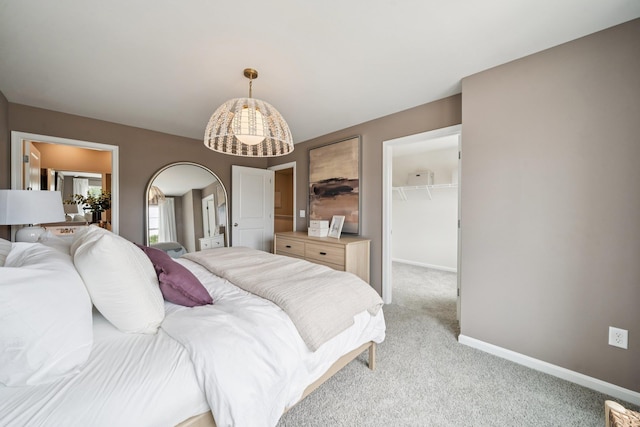240 Camden Dr, Waynesboro, VA 22980 - bedroom featuring a spacious closet, light carpet, arched walkways, and a closet