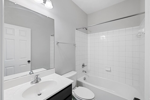 full bathroom featuring toilet, washtub / shower combination, and vanity