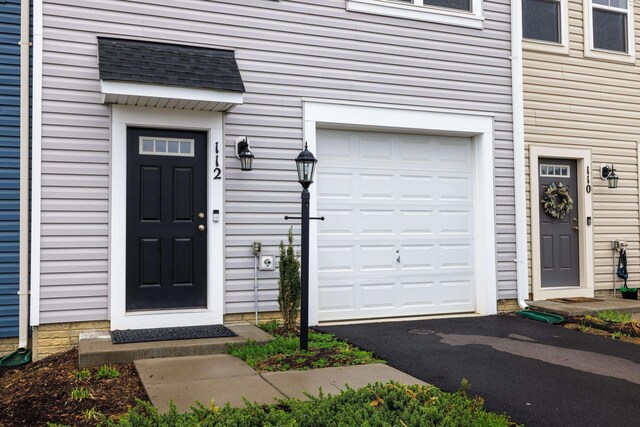 entrance to property with a garage and driveway