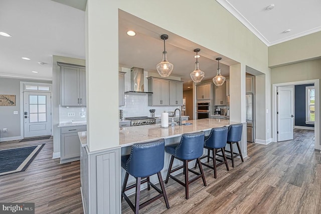 330 Rock Island Rdg, Mineral, VA 23117 - kitchen featuring wall chimney range hood, gray cabinetry, crown molding, baseboards, and recessed lighting