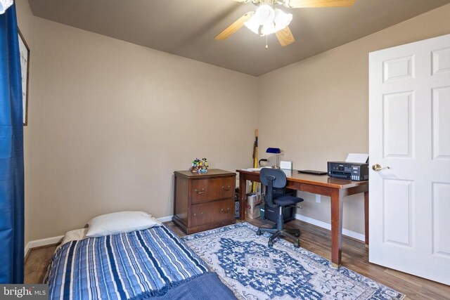 5585 Sperryville Pike, Boston, VA 22713 - bedroom with wood finished floors, baseboards, a desk, and a ceiling fan
