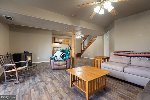 5585 Sperryville Pike, Boston, VA 22713 - living area featuring ceiling fan, a wood stove, dark wood-style floors, baseboards, and stairway