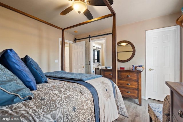 5585 Sperryville Pike, Boston, VA 22713 - bedroom with wood finished floors, a barn door, and ceiling fan