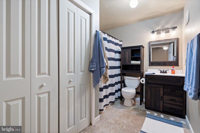 5585 Sperryville Pike, Boston, VA 22713 - bathroom with toilet, vanity, baseboards, and a closet