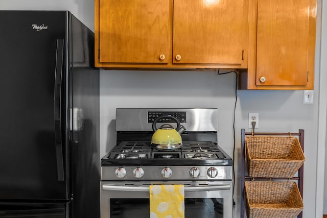 2403 Bare St, Staunton, VA 24401 - kitchen featuring freestanding refrigerator, gas stove, and brown cabinetry