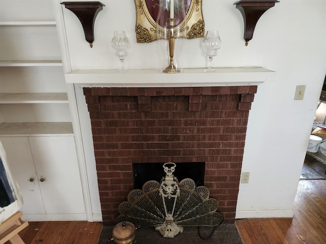 detailed view of a fireplace and wood finished floors
