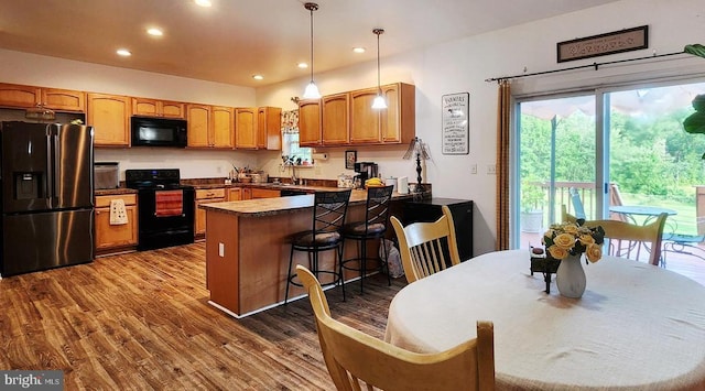 1884 Kennon Rd, Mineral, VA 23117 - kitchen with black appliances, a peninsula, dark wood finished floors, pendant lighting, and recessed lighting