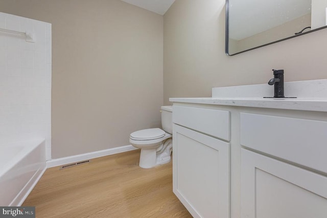 bathroom with vanity, hardwood / wood-style floors, and toilet