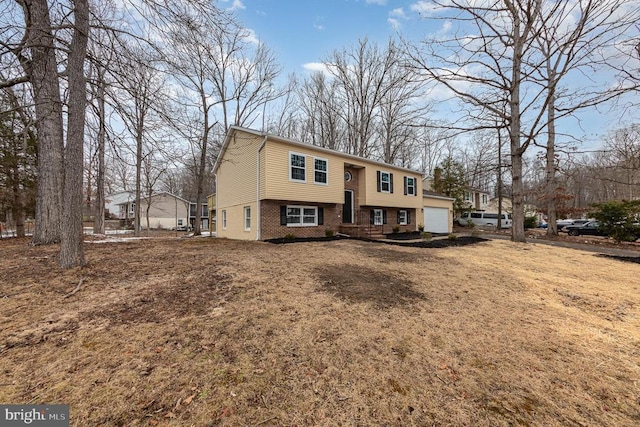 view of front of property with a garage and a front lawn