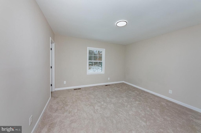 empty room featuring light carpet