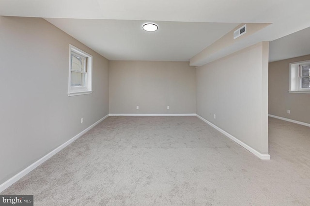 unfurnished room featuring light carpet