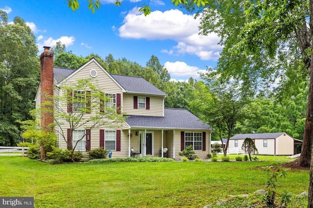 319 Fox Hunters Ln, Madison, VA 22727 - traditional-style house featuring a front lawn, roof with shingles, a chimney, and an outdoor structure