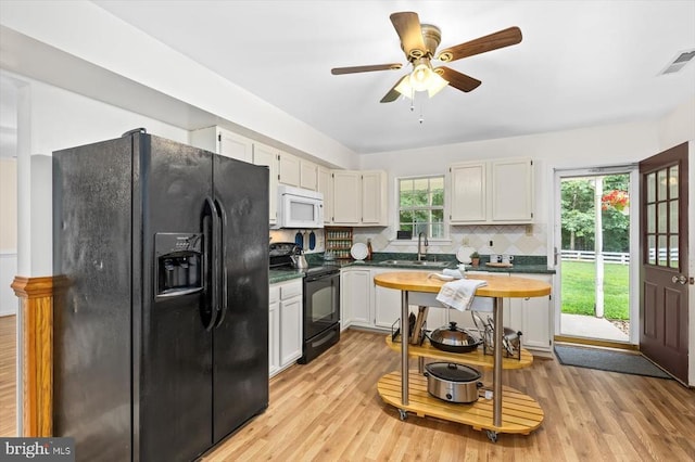 319 Fox Hunters Ln, Madison, VA 22727 - kitchen featuring black appliances, decorative backsplash, light wood-type flooring, ceiling fan, and white cabinetry